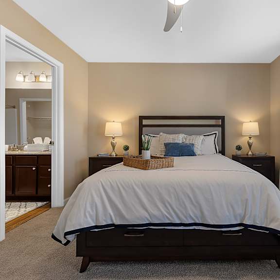 a bedroom with a large bed and a ceiling fan.