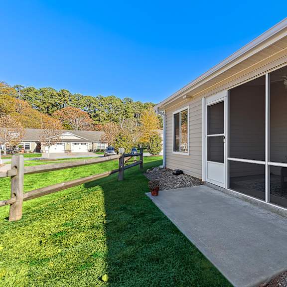 a house with a patio and sliding glass doors.