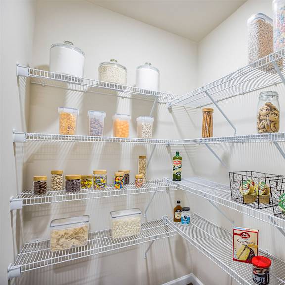 a white refrigerator is filled with jars and containers of food.