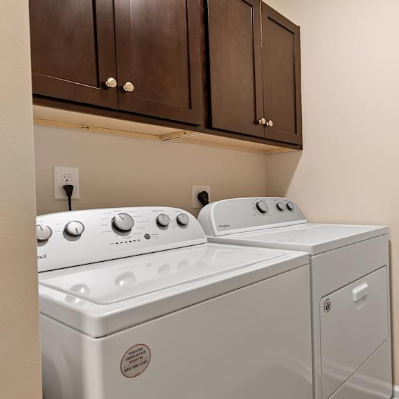 a white washing machine and dryer in a laundry room.