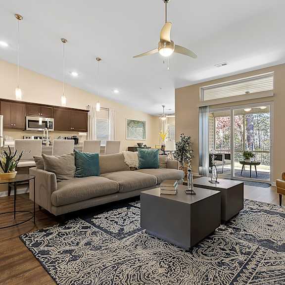 a modern living room with a grey coffee table and a brown sofa.