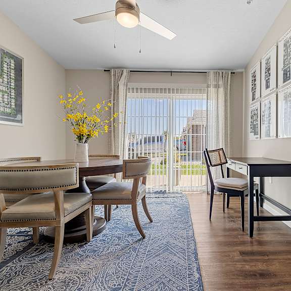 a room with a dining table and chairs.
