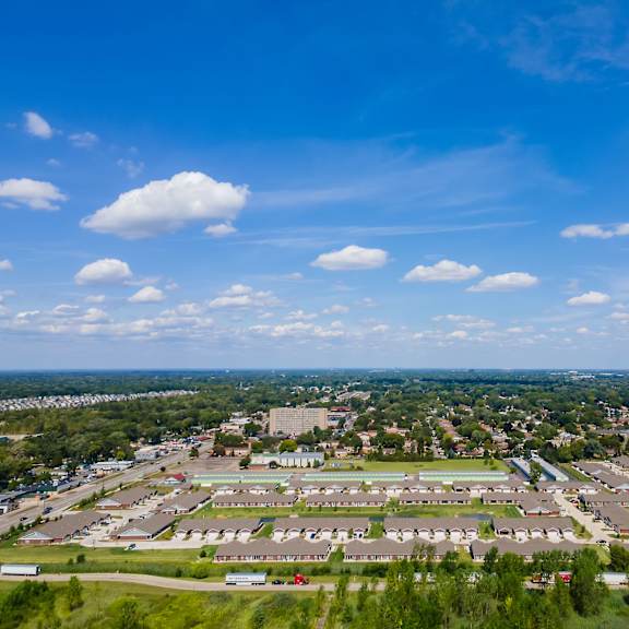a large, open area with a few buildings and a green field.