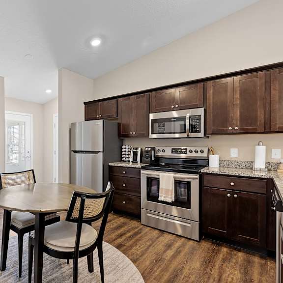 a kitchen with a table and chairs in the middle of the room.