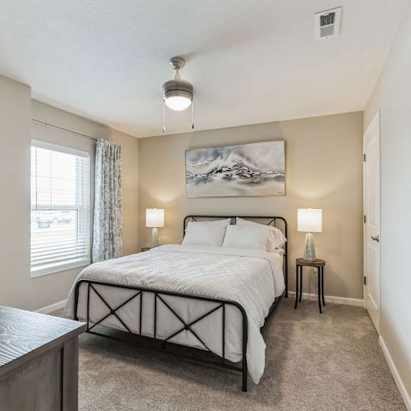 a bedroom with a large bed and a painting on the wall.