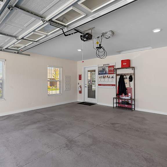 a spacious room with a concrete floor and a ceiling with exposed pipes.