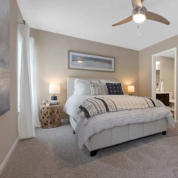 a bedroom with a large bed and a ceiling fan.