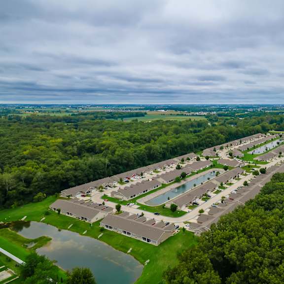 a bird's eye view of a resort with a swimming pool and a lake.