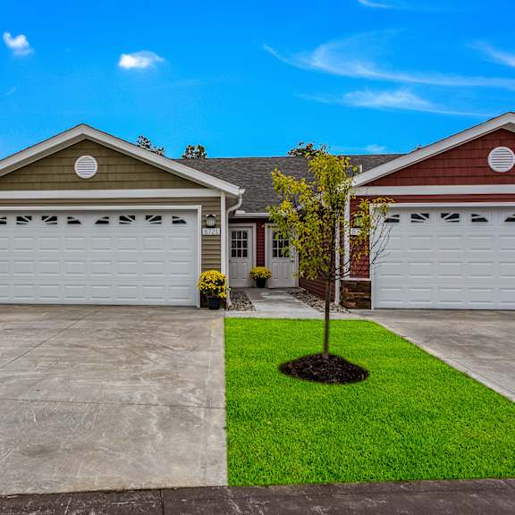 a house with a brown roof and a white garage door.