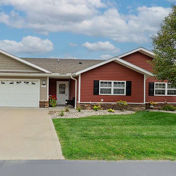 a red house with a white garage door.