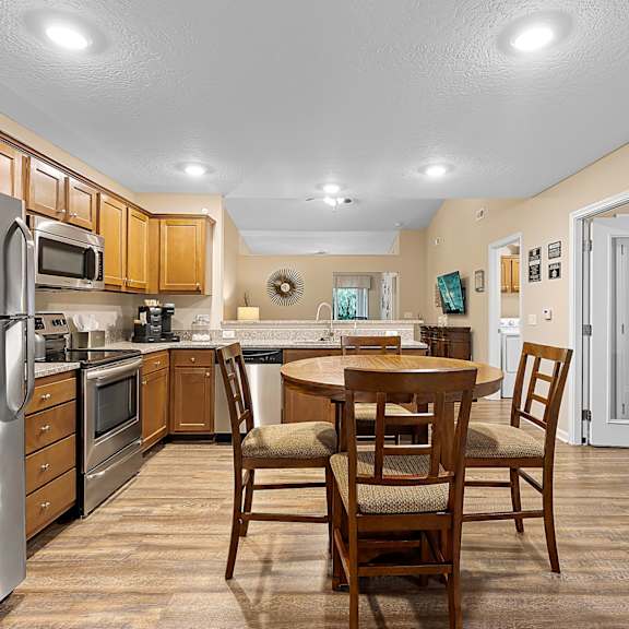 a kitchen with a table and chairs.