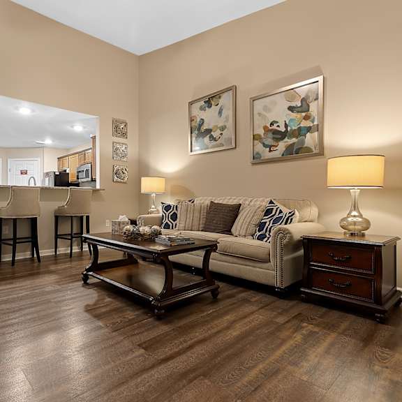 a living room with a couch, coffee table, and two lamps.