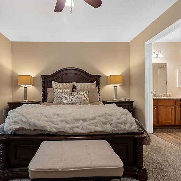 a bedroom with a large bed and a ceiling fan.