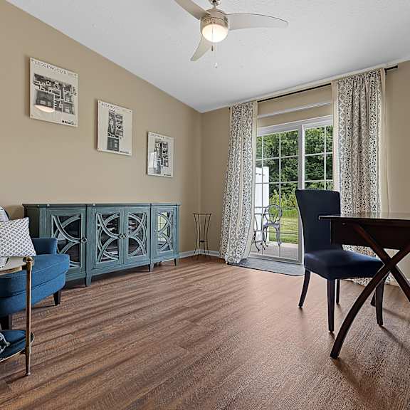 a living room with a blue sofa and a wooden table.