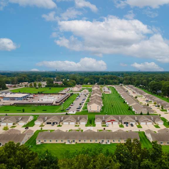a suburban neighborhood with houses and green lawns.
