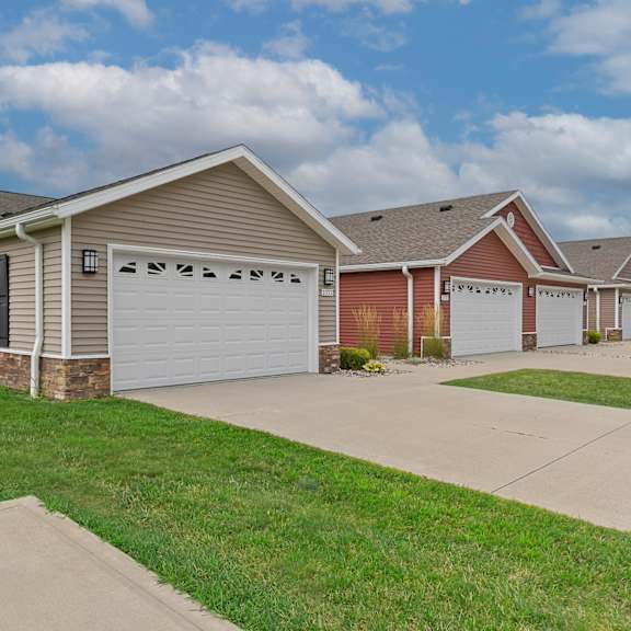a row of houses with garages and driveways.