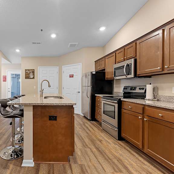 a kitchen with a wooden island and stainless steel appliances.