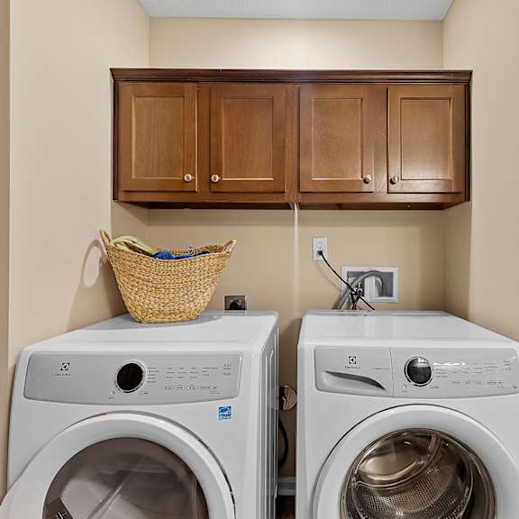 two washing machines in a laundry room.