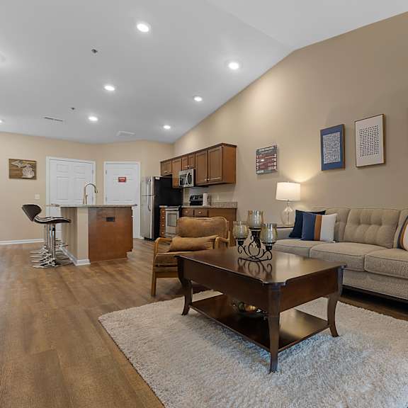 a living room with a couch, coffee table, and pictures on the wall.