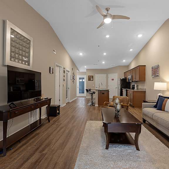 a living room with a brown couch and a wooden coffee table.