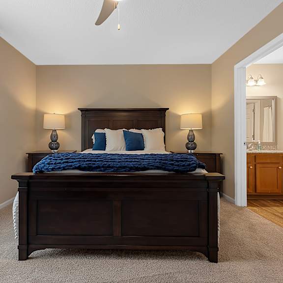 a bedroom with a large bed and a ceiling fan.