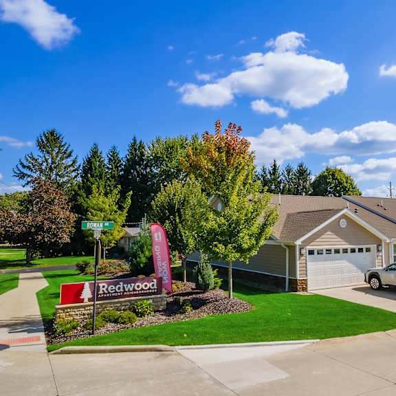 a suburban house with a sign that says redwood.