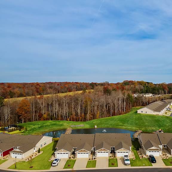 a suburban neighborhood with houses and cars parked in front.