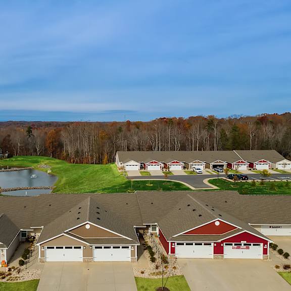 a suburban neighborhood with houses and a pond.
