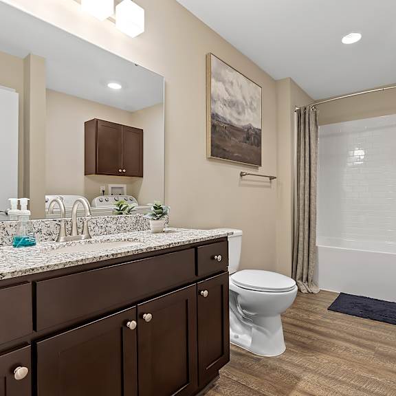 a bathroom with a toilet, sink, and bathtub.