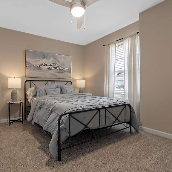 a bedroom with a large bed and a painting on the wall.