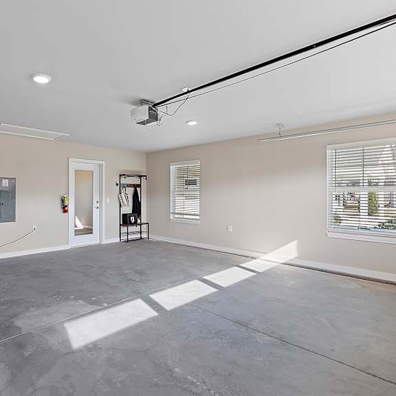 a large empty room with a grey floor and white walls.