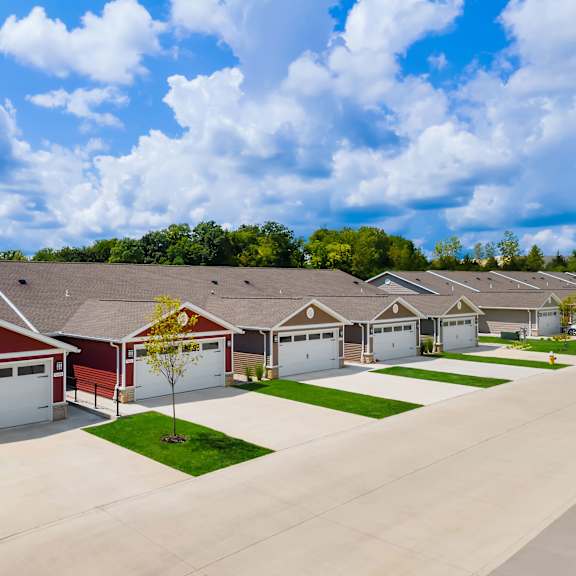 a row of houses with garages and driveways.