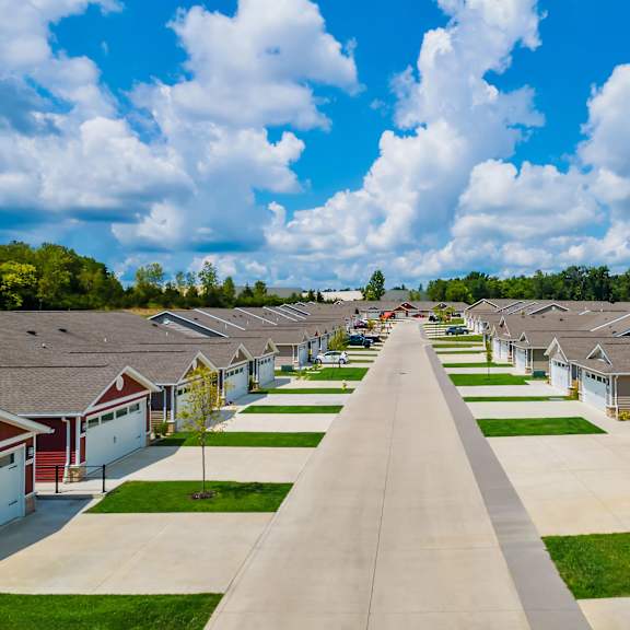 a row of houses with driveways leading to garages.