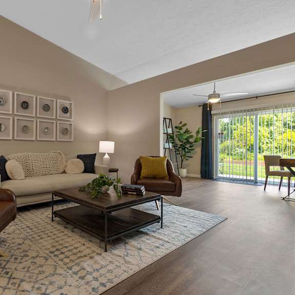 a living room with a brown chair and a white couch.