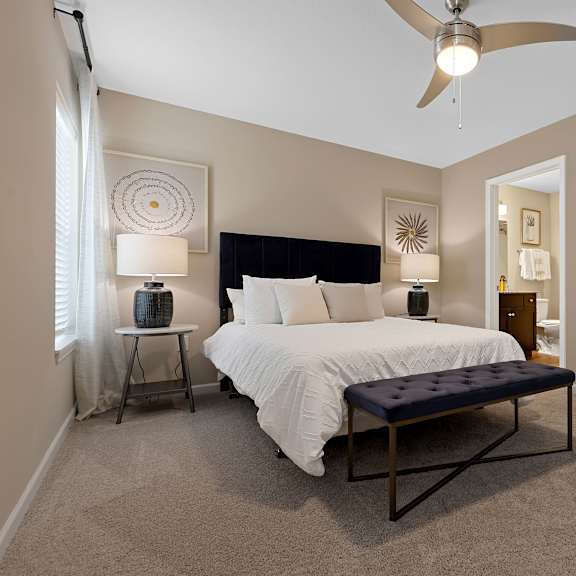 a bedroom with a large bed and a ceiling fan.