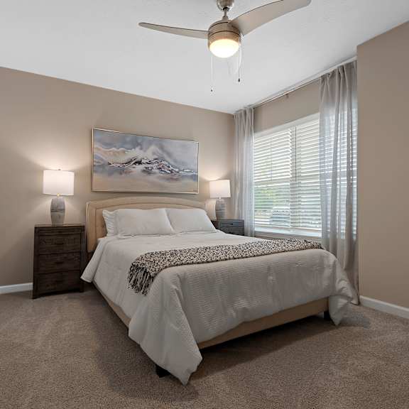 a bedroom with a large bed and a painting on the wall.