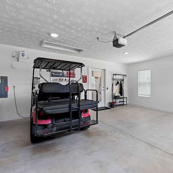 a room with a red and black vehicle and a white wall.