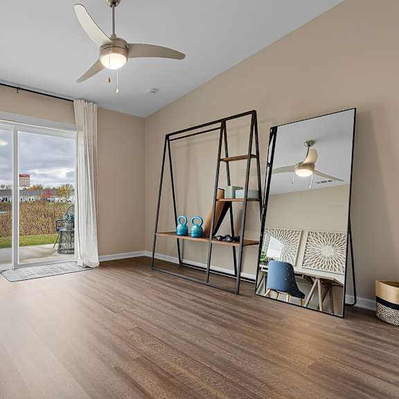 a room with a table, chairs, and a mirror.