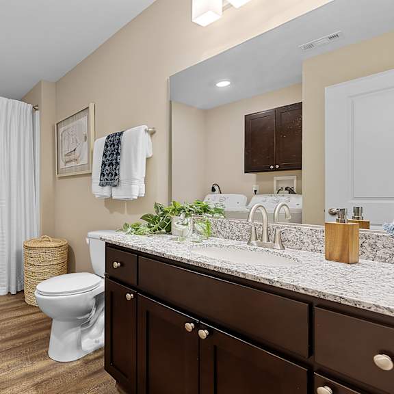 a bathroom with a toilet, sink, and bathtub.