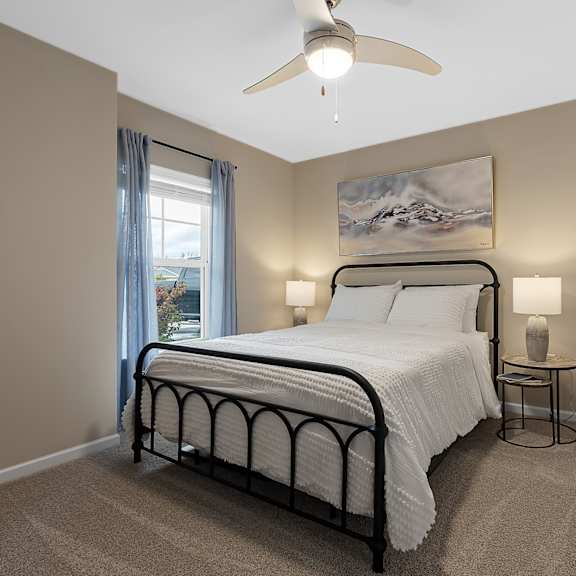 a bedroom with a large bed and a ceiling fan.