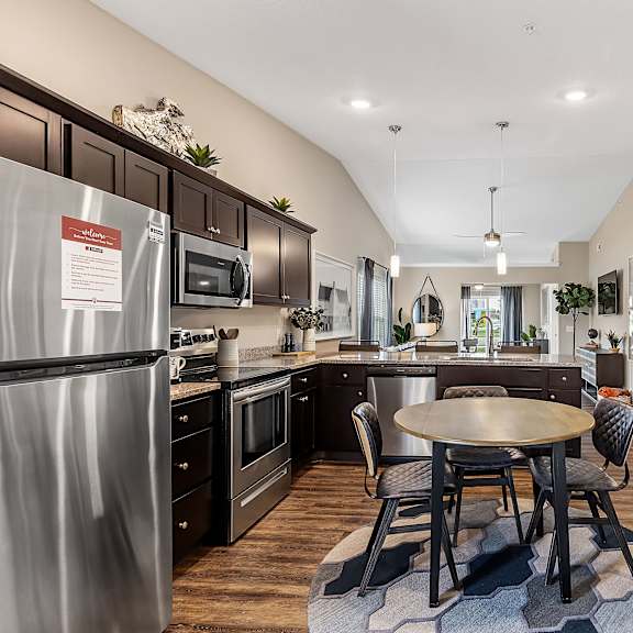 a kitchen with a table and chairs in the middle of the room.
