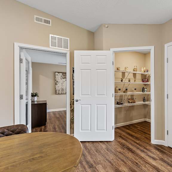a room with a brown table and a white door.