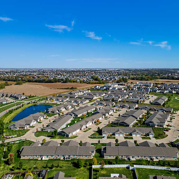 a suburban neighborhood with houses and a lake.