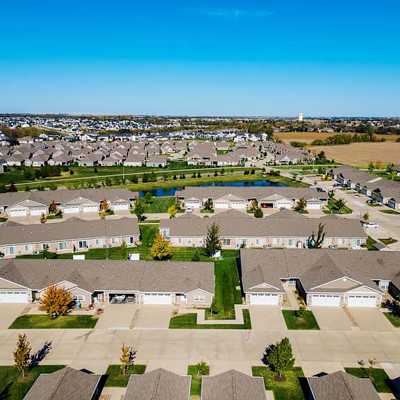 a suburban neighborhood with rows of houses and a clear blue sky.