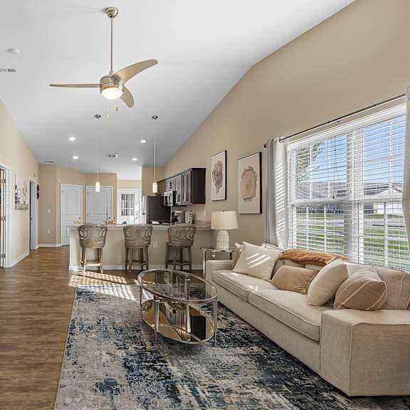 a living room with a white couch and a television.