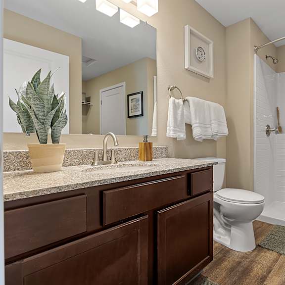 a bathroom with a white toilet and a white shower curtain.