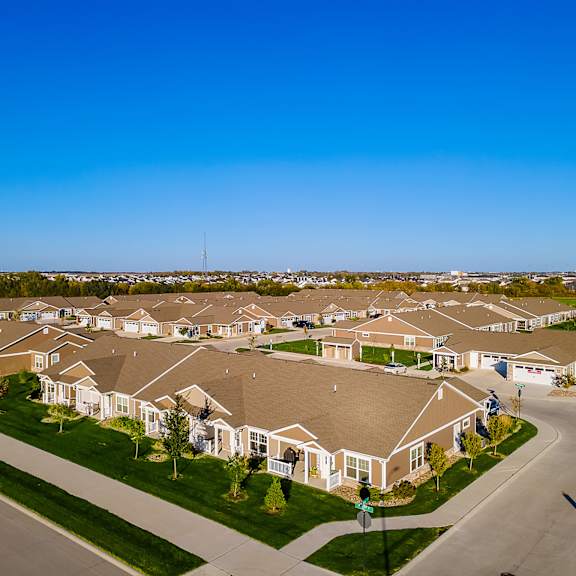 a suburban neighborhood with houses and a clear blue sky.