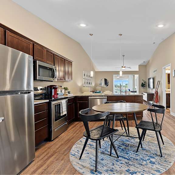 a kitchen with a table and chairs in the middle of the room.