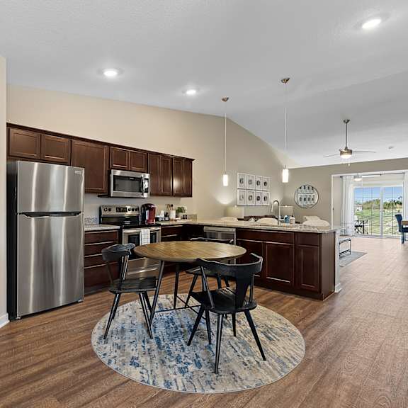 a kitchen with a table and chairs in the middle of the room.