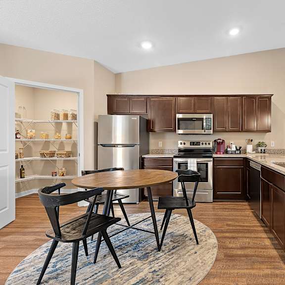 a modern kitchen with a table and chairs.